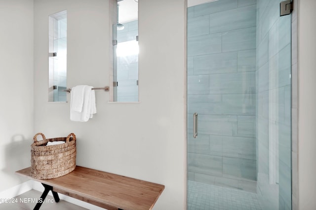 bathroom featuring a shower with shower door