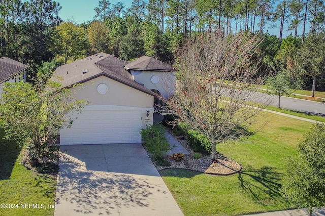 view of front of home featuring a front yard and a garage