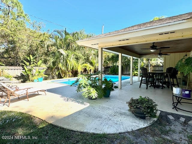 view of patio with a fenced in pool and ceiling fan