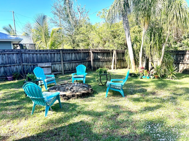 view of yard with a fire pit