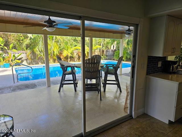 interior space with ceiling fan