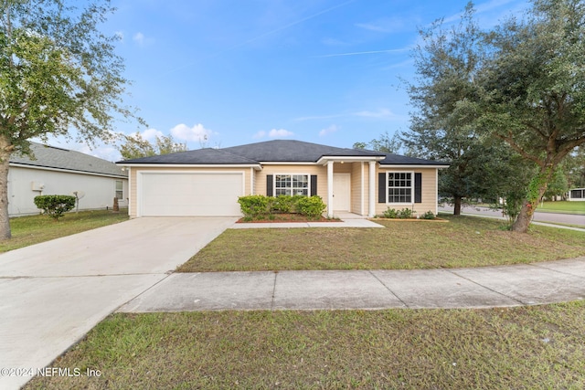 ranch-style home with a garage and a front yard