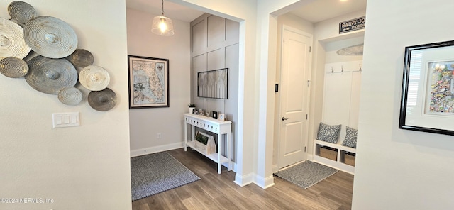 hallway with baseboards and wood finished floors