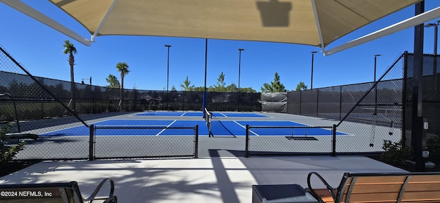 view of tennis court with fence