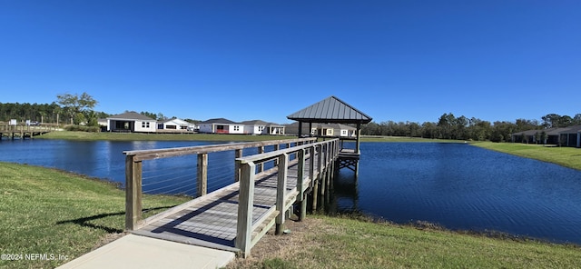 dock area featuring a gazebo, a lawn, and a water view