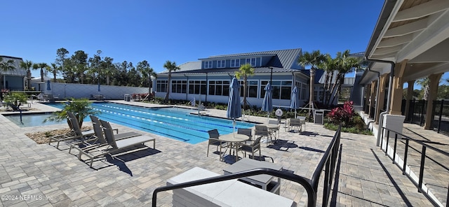 pool featuring fence and a patio