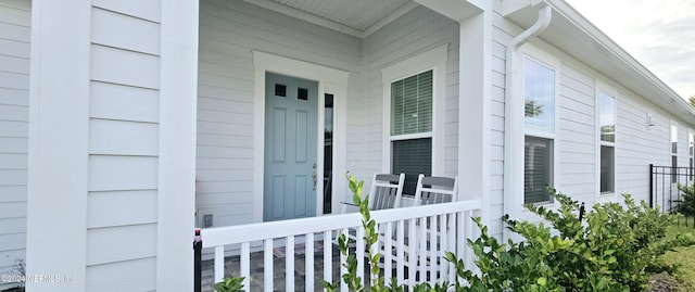 view of exterior entry with a porch