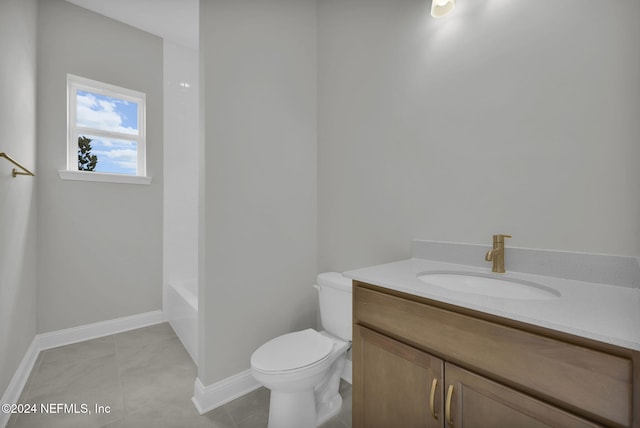 bathroom featuring tile patterned flooring, vanity, and toilet