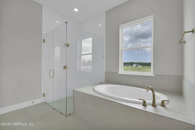 bathroom featuring separate shower and tub