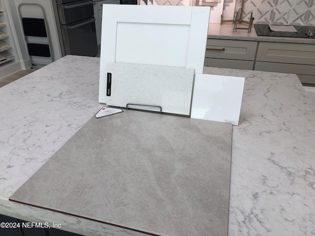 kitchen featuring stainless steel fridge and gray cabinets