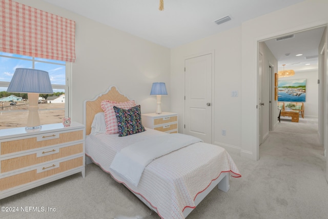 bedroom featuring light colored carpet