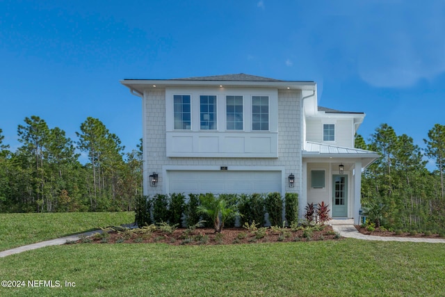 view of front of home featuring a garage and a front lawn