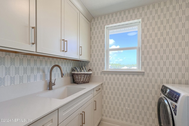 laundry room with cabinets, washer / dryer, and sink