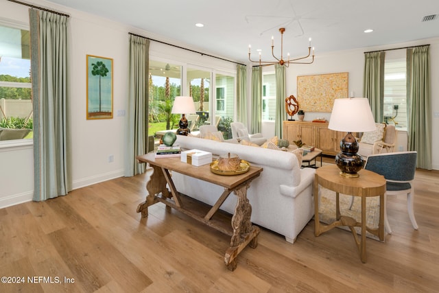 interior space with plenty of natural light, a chandelier, and light hardwood / wood-style flooring