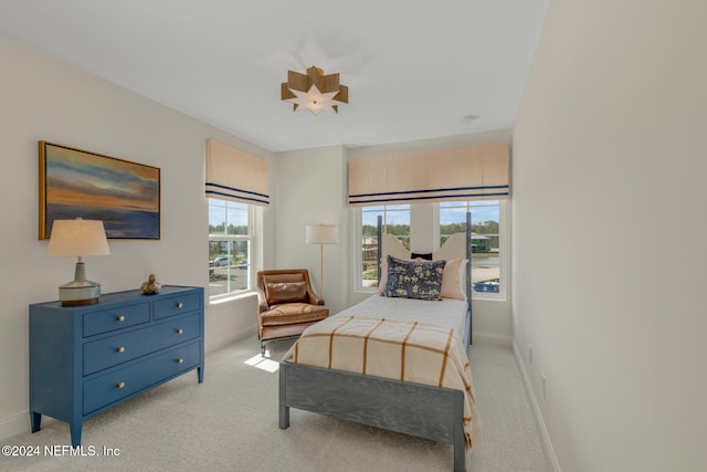 bedroom featuring light carpet