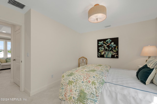 bedroom featuring light colored carpet