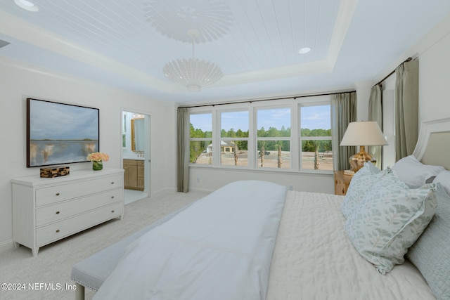 bedroom with wooden ceiling, a raised ceiling, connected bathroom, light colored carpet, and a chandelier