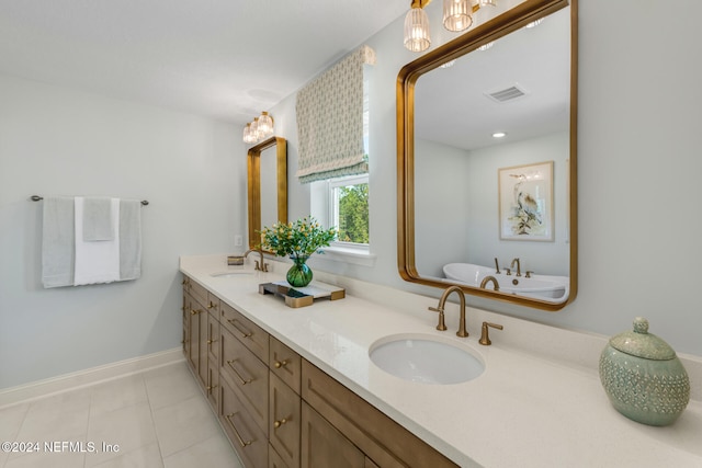 bathroom with tile patterned flooring, vanity, and a washtub