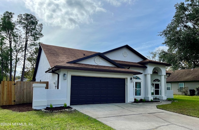 view of front of house with a garage and a front lawn