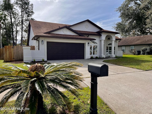 view of front of home featuring a garage and a front lawn