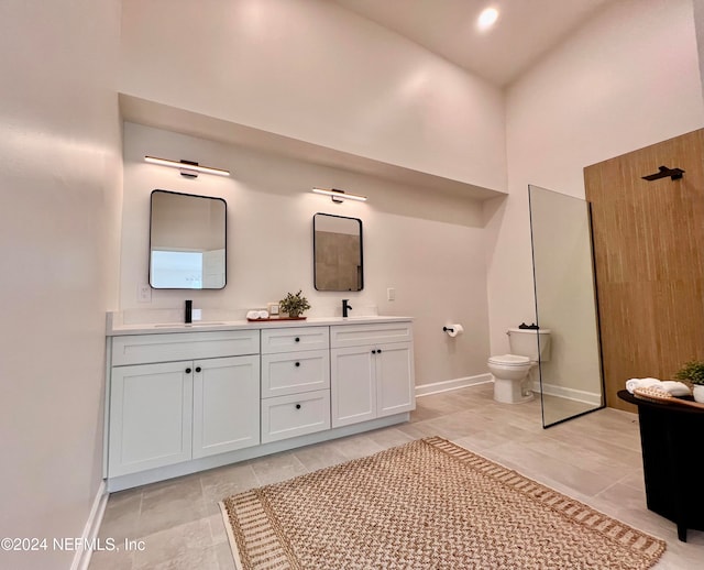 bathroom with vanity, high vaulted ceiling, and toilet