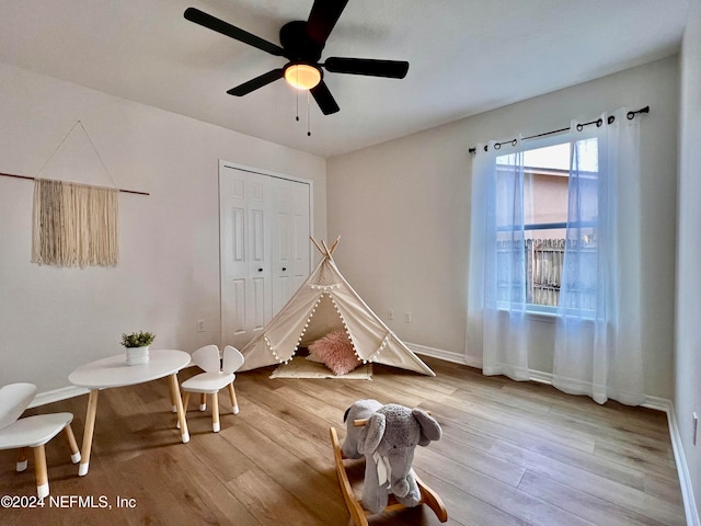 recreation room featuring light hardwood / wood-style flooring and ceiling fan