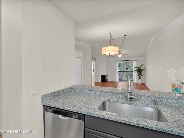 kitchen with sink, light stone counters, crown molding, decorative light fixtures, and dishwasher