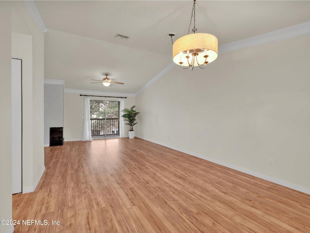 unfurnished living room with ornamental molding, a brick fireplace, ceiling fan with notable chandelier, and light hardwood / wood-style floors