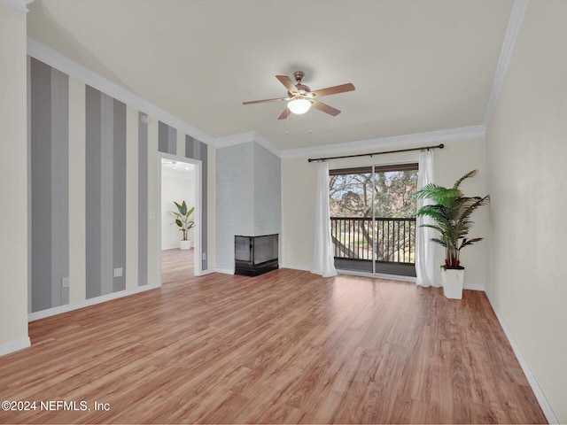 unfurnished living room with crown molding, light hardwood / wood-style floors, and a wood stove