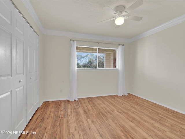 unfurnished bedroom with light hardwood / wood-style flooring, ceiling fan, ornamental molding, a textured ceiling, and a closet