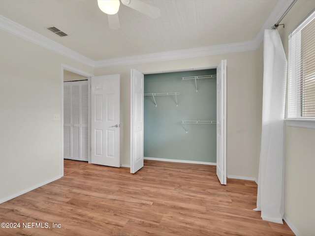 unfurnished bedroom featuring crown molding, ceiling fan, and light hardwood / wood-style flooring