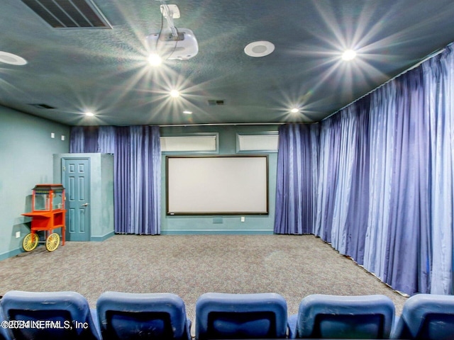 home theater room featuring a textured ceiling and carpet