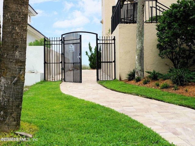 view of gate featuring a yard