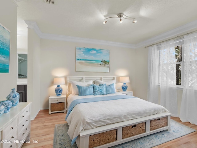 bedroom featuring ornamental molding and light hardwood / wood-style floors