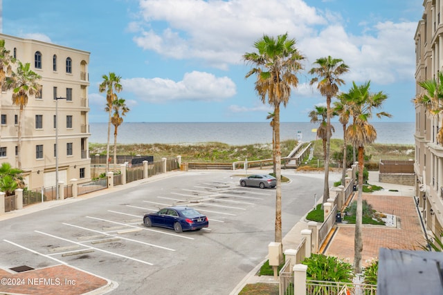 view of parking / parking lot with a water view