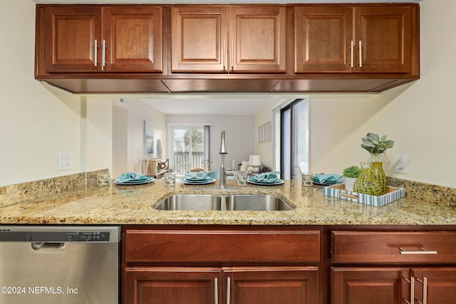 kitchen featuring kitchen peninsula, light stone countertops, dishwasher, and sink