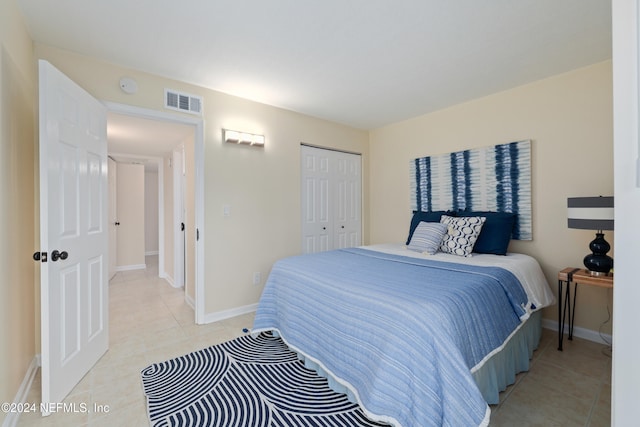 tiled bedroom with a closet