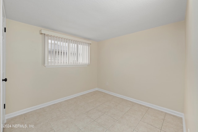 spare room featuring light tile patterned floors