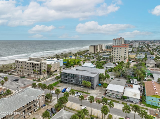 birds eye view of property with a water view and a view of the beach