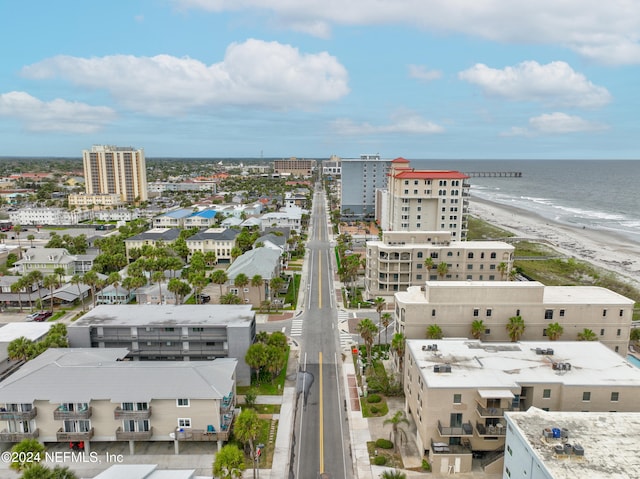 bird's eye view featuring a water view and a beach view