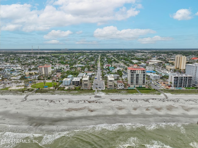 birds eye view of property featuring a beach view and a water view