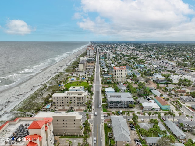 bird's eye view with a water view and a beach view