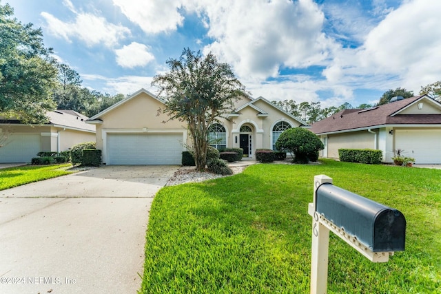 view of front of property with a front lawn and a garage