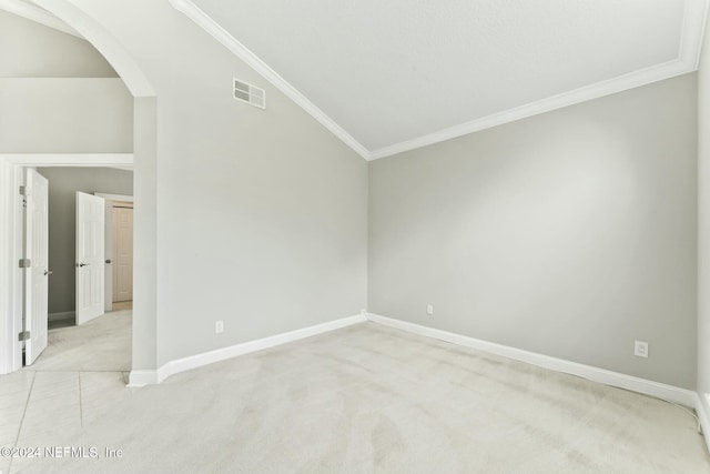 unfurnished room featuring light colored carpet, crown molding, and vaulted ceiling