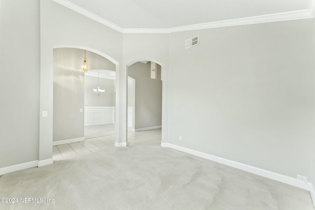 unfurnished room featuring light colored carpet, crown molding, and an inviting chandelier