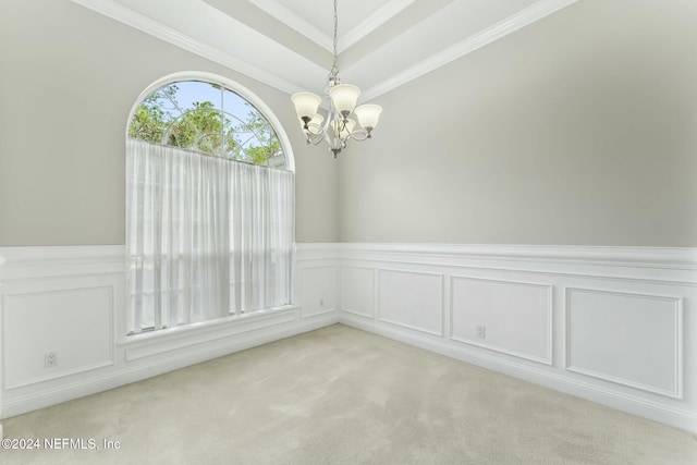 carpeted empty room with a notable chandelier and crown molding