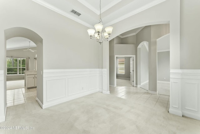 carpeted spare room with ceiling fan with notable chandelier, ornamental molding, and lofted ceiling