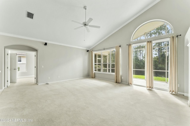 carpeted empty room featuring high vaulted ceiling, ceiling fan, and a healthy amount of sunlight