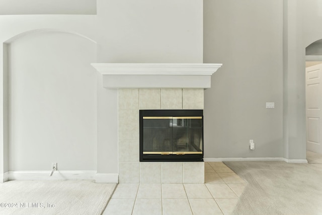 room details featuring carpet and a tile fireplace