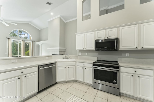 kitchen with ceiling fan, sink, light tile patterned flooring, white cabinets, and appliances with stainless steel finishes